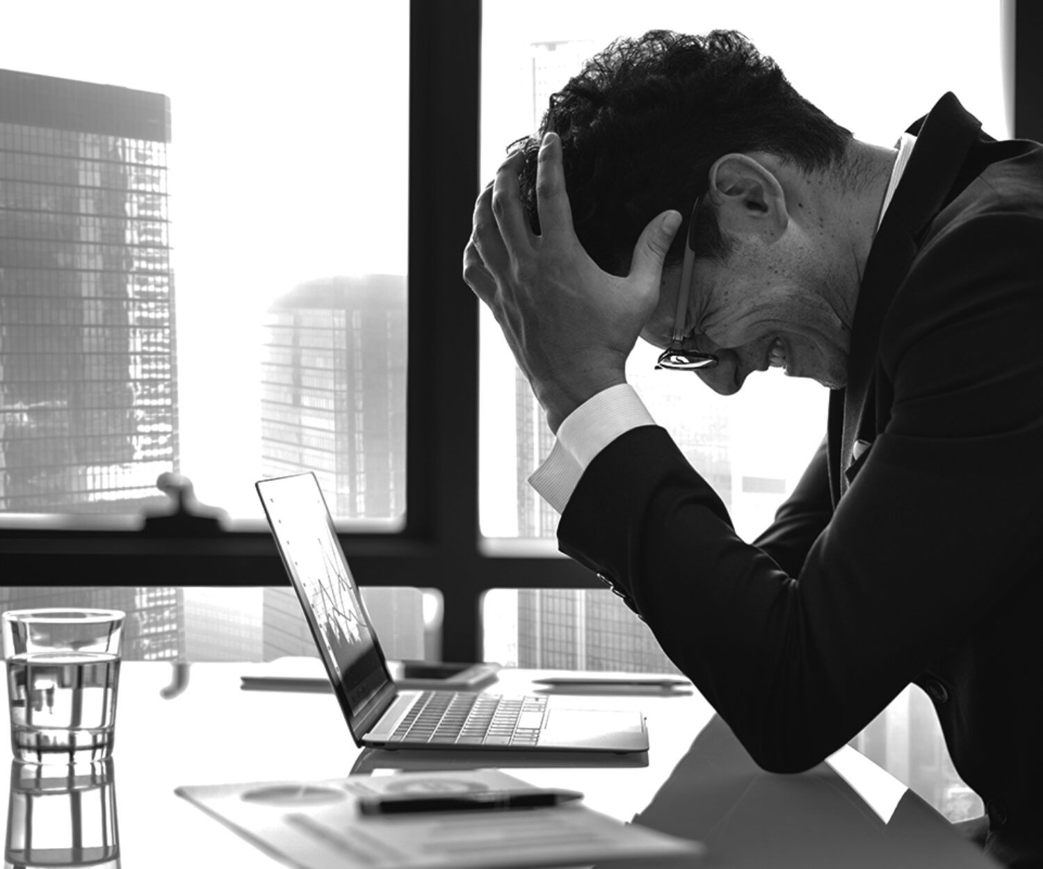 Stressed young businessman overworking